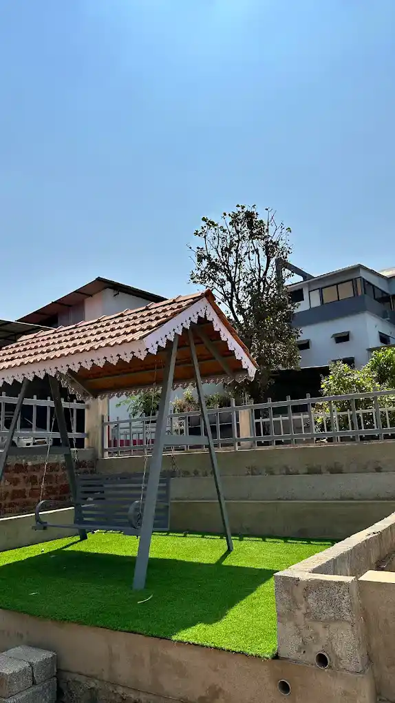 Outdoor garden dining area surrounded by greenery at B Hive Resort Londa