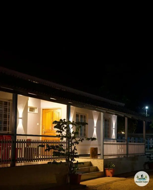 Illuminated dormitory building at night at B Hive riverside resort near Dandeli