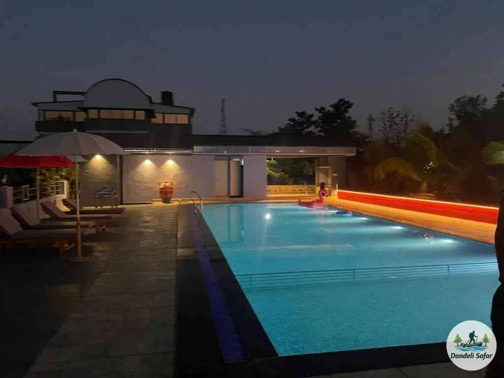 Beautifully lit swimming pool at night creating serene ambiance at B Hive Resort