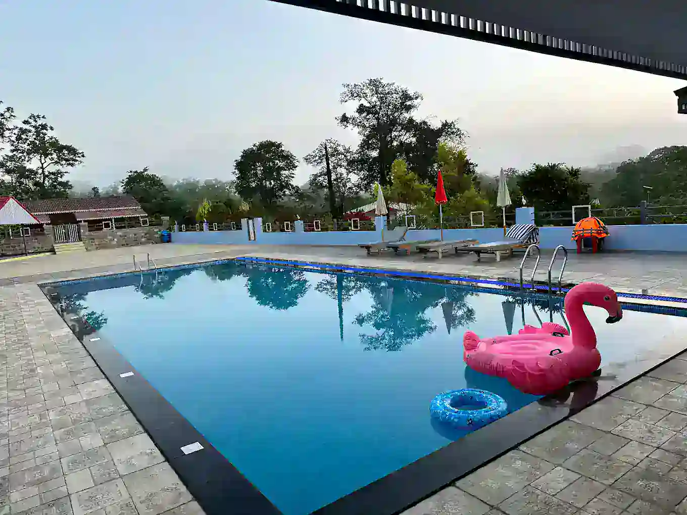 Sunset view over swimming pool at B Hive riverside resort Londa